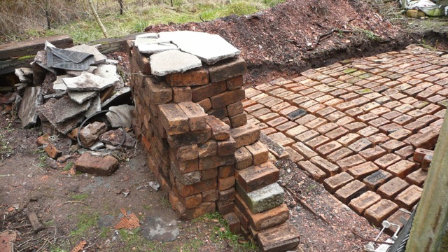 One layer of bricks down, the gaps get filled with concrete and another layer on top.